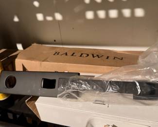 New in the box Baldwin Reserve front door handle, a pair of new black Baldwin sliding door hardware and hardware, new in the box sliding door handle and a pair of sliding door hanger/rollers, new, never used one in original box