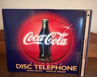 A218 - $40. Coca-Cola disc telephone. Still in box. Brand new.