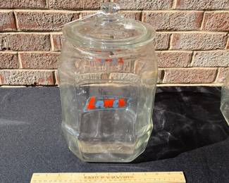 A78 - $70. Lance glass jar. Detailed Lance name top. Measures 12.5" tall. Has some small chipping on the top rim.