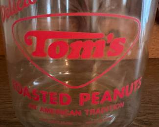 A207 - $55. Tom’s toasted peanuts jar. Measures 10.5 inches tall. In good, used shape. No chips or cracks seen.