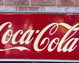 A24 - $700. Coca-Cola Robertson metal 1940s-1950s sign. Measures 54” x 18”.