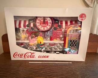 A214 - $40. Coca-Cola clock. box measures 22 x 15. In good shape, still in box. A few paint imperfections.