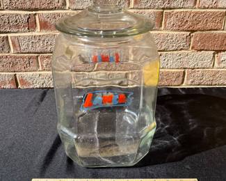 A77 - $65. Lance glass jar. Measures 12.5” tall. Plain glass lid.