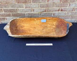 A113 - $95. Primitive Dough Bowl w/ old repair. Measures 33 1/2” x 13”.