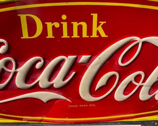 A40 - $325. 1950s Canadian red and yellow Coca-Cola sign. Measures 29.5” x by 12.25”. Some bent and creased metal.