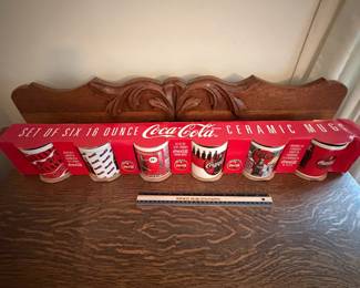 A220 - $20. Set of six ceramic Coca-Cola mugs. Still in package, they look brand new.