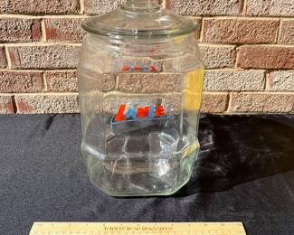 A77 - $65. Lance glass jar. Measures 12.5” tall. Plain glass lid.