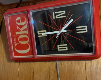 A134 - $40. 1980s enjoy Coke Wall clock. Not working. Measures 21" x 13" tall.
