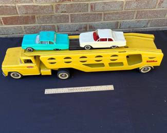 A98 - $160. 1960’s Tonka car carrier #40 with two rider cars. Measures measures 27.25” long.