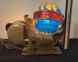 A145 - $165. 1976 Schlitz beer lighted motion globe clock. Like new condition. Works and rotates like it should. Measures 14" x 9.5" tall.