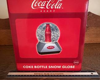 A217 - $25. Coke bottle snow globe. Still in box. Box measures 10 inches tall.