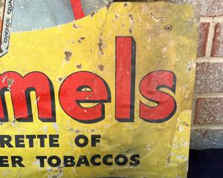 A2 - $225. 1950s Camel Cigarettes counter display die-cut. Measures 33" tall. In fragile condition. Has rips and scrapes throughout. Slightly bowed at the bottom.