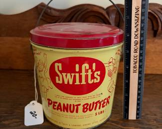 A203 - $20. Swift’s peanut butter 5 pound bucket. Measures 6.25 inches tall. Some dents and paint rubbed off. Otherwise good, used vintage shape.