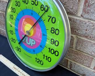 A31 - $100. 1970s 7-Up Thermometer. Measures 12.5 diameter.