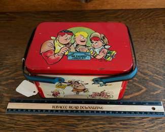 A228 - $20. Joe Palooka lunch kit. Measures 7“ x 5“ 4 inches tall. Has paint wear and scratches on the inside. Overall good, used shape.