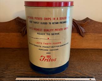 A208 - $50. Lays potato chips can. Measures 11.25 inches tall. It has some dents and scratches throughout.