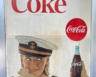 A26 - $85. 1970s Captain’s Navy Cap Coca-Cola sign. Measures 19” x 36”.