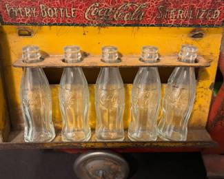 A171 - $150. 1931 Metalcraft Bottle Truck. Metal Wheels with 10 small glass bottles.
