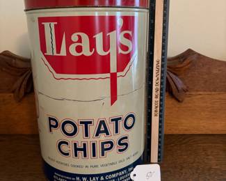 A208 - $50. Lays potato chips can. Measures 11.25 inches tall. It has some dents and scratches throughout.