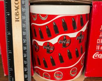 A220 - $20. Set of six ceramic Coca-Cola mugs. Still in package, they look brand new.