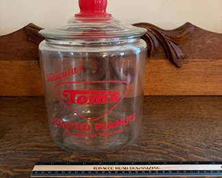 A207 - $55. Tom’s toasted peanuts jar. Measures 10.5 inches tall. In good, used shape. No chips or cracks seen.