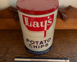 A208 - $50. Lays potato chips can. Measures 11.25 inches tall. It has some dents and scratches throughout.