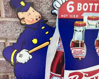 A17 - $85. 1940s Pepsi-Cola Pepsi & Pete Cardboard display counter sign. Measures 22“ x 14.5“. This sign has some creasing on one policeman’s hat. In good vintage shape. Marked 40-20 in the bottom right corner.