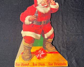 A41 - $80. 1960s stand-up Coca-Cola Santa. Measures 13" x 19.75". Some bent and ripped fingers.