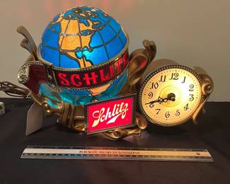 A145 - $165. 1976 Schlitz beer lighted motion globe clock. Like new condition. Works and rotates like it should. Measures 14" x 9.5" tall.