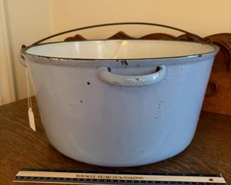 A205 - $50. Light blue cast-iron bowl with handle. Measures 7 inches tall 15 1/2 inches diameter. Has crazing on the bottom of the bowl. And good used shape.