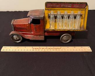 A171 - $150. 1931 Metalcraft Bottle Truck. Metal Wheels with 10 small glass bottles.