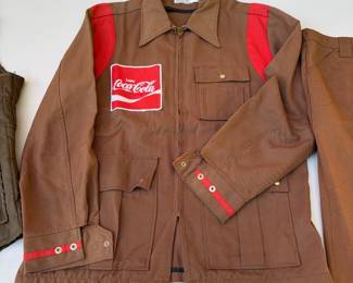 A155 - $60. Vintage Coca-Cola uniform clothing lot. Includes one jacket, one vest, seven pairs of pants. The jacket is in decent condition. Most of the pants have a stain or tear. Vest M/L. Jacket M. Pants Waist 34"