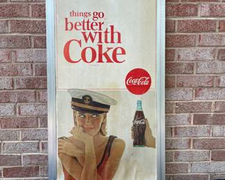 A26 - $85. 1970s Captain’s Navy Cap Coca-Cola sign. Measures 19” x 36”.
