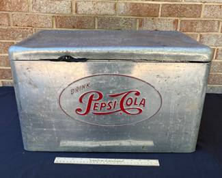 A105 - $125. 1950s Pepsi-Cola cooler. Measures 22“ x 13“.