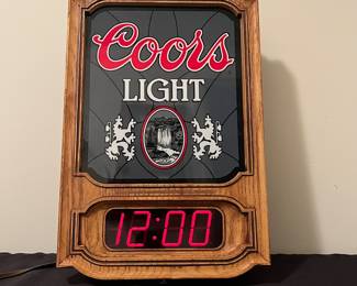 A136 - $35. 1981 gray Coors light and digital wall clock. Top not lighting needs a bulb. Light scuff on the face. Measures 10.75" x 16" tall.