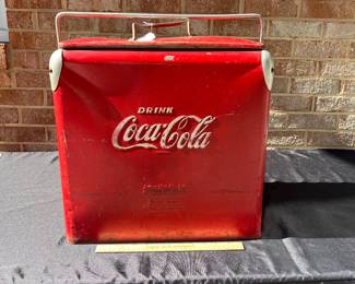 A42 - $100. Vintage Coca-Cola Cooler by Acton. Measures 17” x 12” x 19.5”. This has some wear and rubbed off paint and scratches. Handle works to lock it and has insert tray.