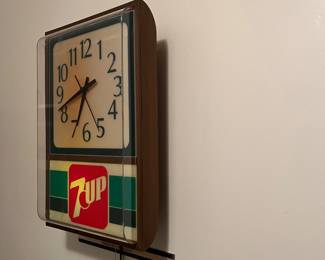 A138 - $60. 7-Up lighted wall clock. Clock works perfectly. The light flickers. Might need a new bulb. Measures 12" x 18" tall.
