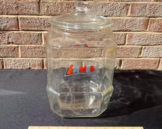 A78 - $70. Lance glass jar. Detailed Lance name top. Measures 12.5" tall. Has some small chipping on the top rim.