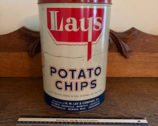 A208 - $50. Lays potato chips can. Measures 11.25 inches tall. It has some dents and scratches throughout.