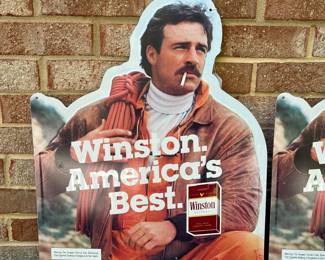 A14 - $25 each. Winston cigarettes, metal signs. (2) Year 1985. Measures 17.75“ x 21.75“. Has a few light scrapes otherwise good, vintage shape.