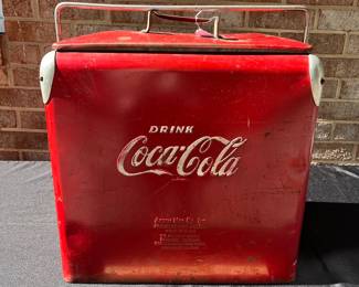 A42 - $100. Vintage Coca-Cola Cooler by Acton. Measures 17” x 12” x 19.5”. This has some wear and rubbed off paint and scratches. Handle works to lock it and has insert tray.