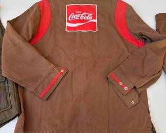 A155 - $60. Vintage Coca-Cola uniform clothing lot. Includes one jacket, one vest, seven pairs of pants. The jacket is in decent condition. Most of the pants have a stain or tear. Vest M/L. Jacket M. Pants Waist 34"