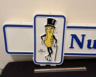A192 - $125. 1980s Mr. Peanut Nut Center - Double sided hard plastic sign. Measures 49" x 13".