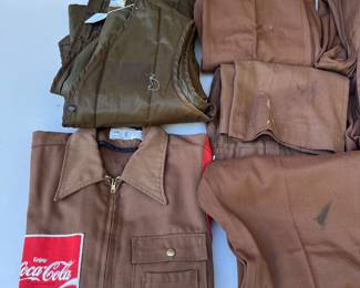 A155 - $60. Vintage Coca-Cola uniform clothing lot. Includes one jacket, one vest, seven pairs of pants. The jacket is in decent condition. Most of the pants have a stain or tear. Vest M/L. Jacket M. Pants Waist 34"
