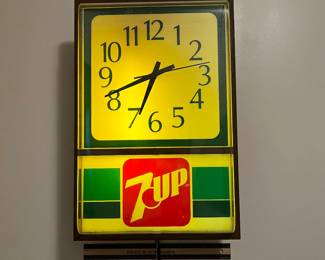 A138 - $60. 7-Up lighted wall clock. Clock works perfectly. The light flickers. Might need a new bulb. Measures 12" x 18" tall.