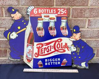 A17 - $85. 1940s Pepsi-Cola Pepsi & Pete Cardboard display counter sign. Measures 22“ x 14.5“. This sign has some creasing on one policeman’s hat. In good vintage shape. Marked 40-20 in the bottom right corner.