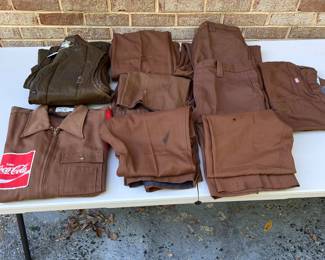 A155 - $60. Vintage Coca-Cola uniform clothing lot. Includes one jacket, one vest, seven pairs of pants. The jacket is in decent condition. Most of the pants have a stain or tear. Vest M/L. Jacket M. Pants Waist 34"