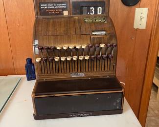 A177 - $100. 1950s Woodgrain Cash Register. Model 126(2). We have the key and the drawer opens.
