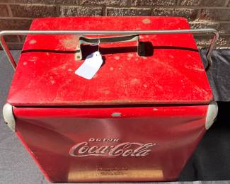 A42 - $100. Vintage Coca-Cola Cooler by Acton. Measures 17” x 12” x 19.5”. This has some wear and rubbed off paint and scratches. Handle works to lock it and has insert tray.