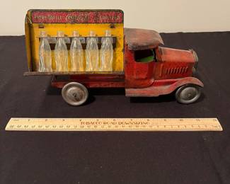 A171 - $150. 1931 Metalcraft Bottle Truck. Metal Wheels with 10 small glass bottles.